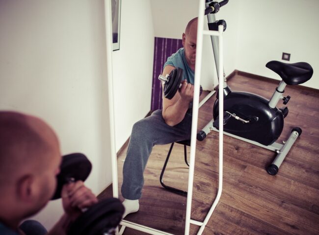 Athlete performing a barbell squat exercise, showcasing proper form and engaging lower body muscles for effective strength training and muscle building.